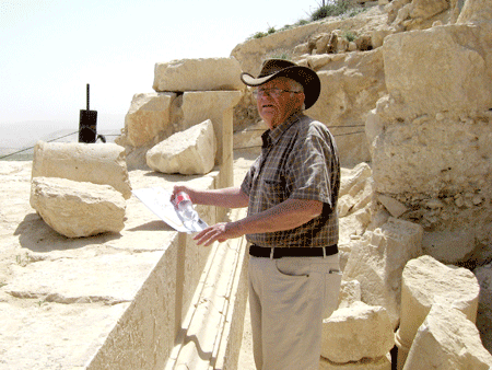 Ehud Netzer by Herod's tomb monument in 2009